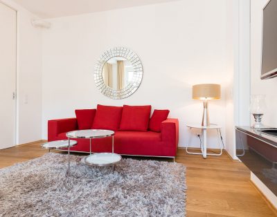 Red Sofa & Blue Dreams: Chic 1BR with Designer Details & Courtyard Views
